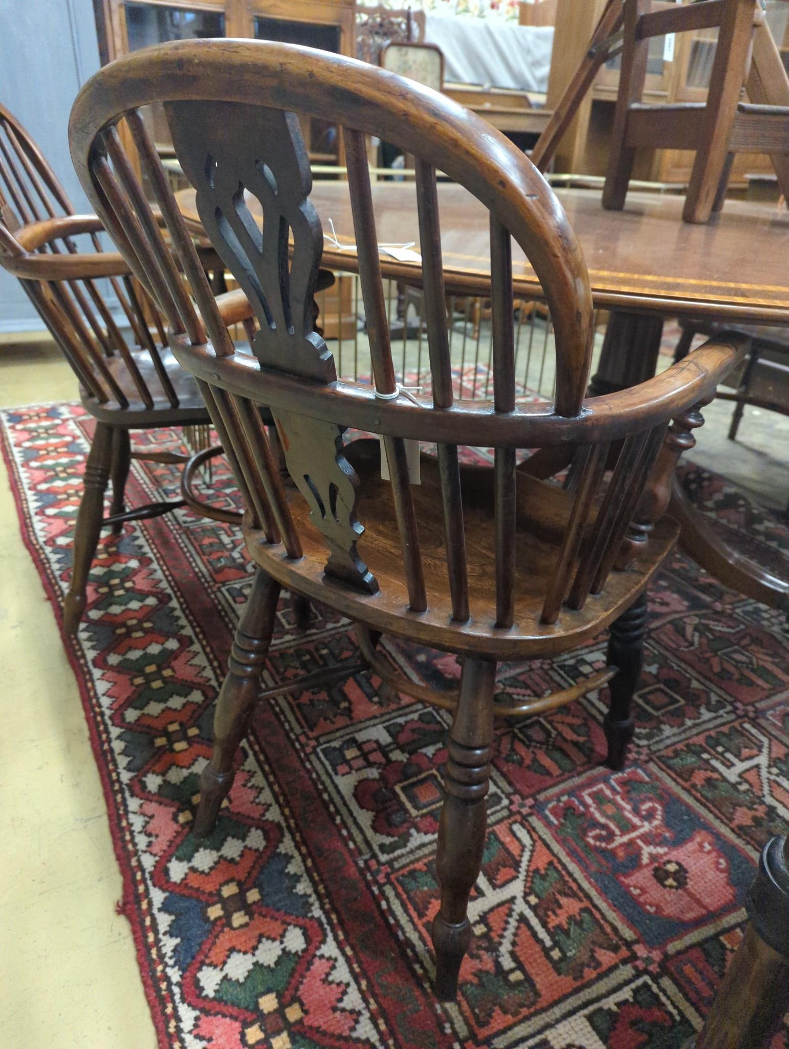 A near pair of mid 19th century Nottingham Area yew and elm Windsor elbow chairs with crinoline stretchers